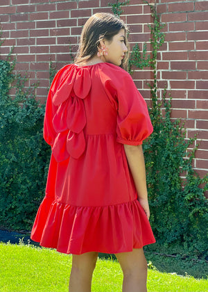 <img src="girl in red dress.jpg" alt="girl in red dress with bow back and puff sleeve">