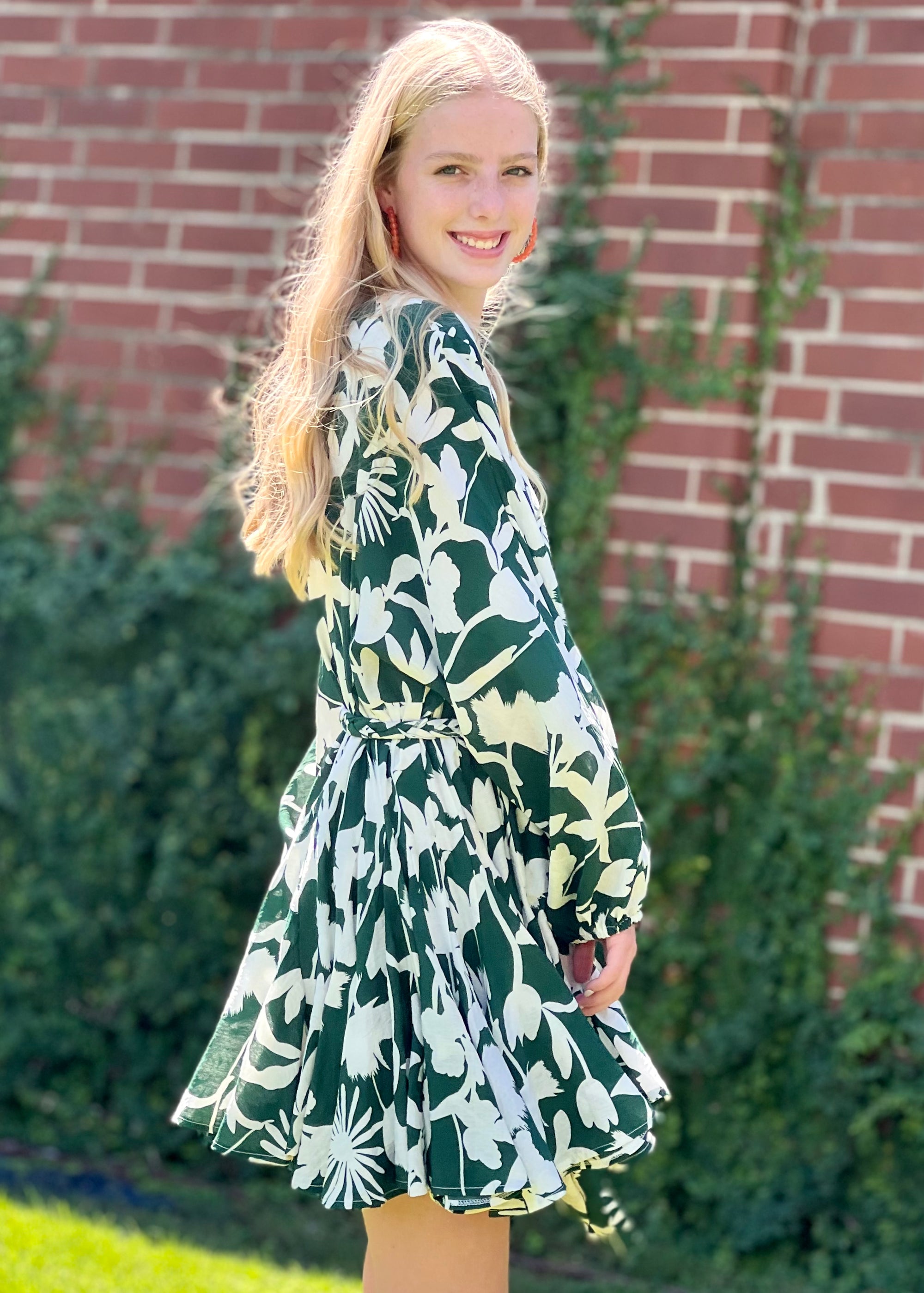 <img src="girl in green mini dress.jpg" alt="girl wearing pink mini green floral dress with orange hoop earring">