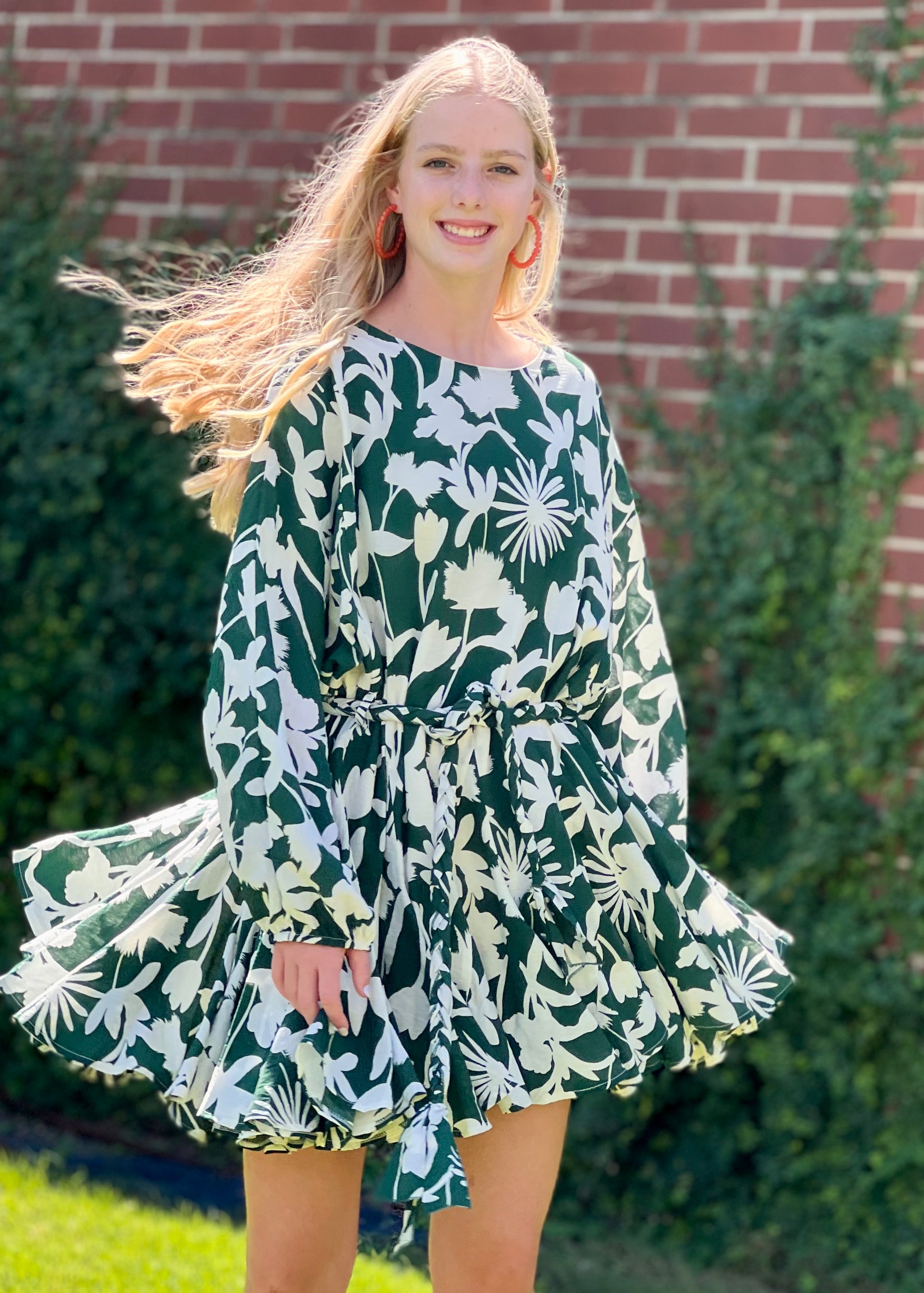 <img src="girl in green mini dress.jpg" alt="girl wearing pink mini green floral dress with orange hoop earring">