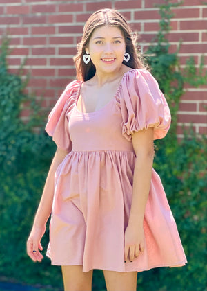 <img src="girl in pink dress.jpg" alt="girl wearing pink mini dress with puff sleeves and heart earrings">